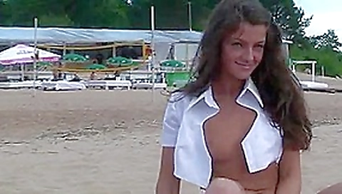 Tanned Russian brunette gets nude on the beach Tanned Russian brunette gets nude on the beach