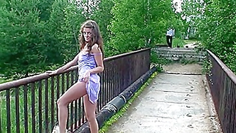 Petite chick does not shy to pose naked on the bridge Petite chick does not shy to pose naked on the bridge