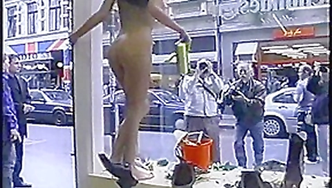 Nude girl washing windows in public Nude girl washing windows in public